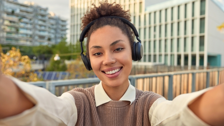 A smiling female college student taking a selfie | 7 Coping Mechanisms for Students and How to Manage Stress in College