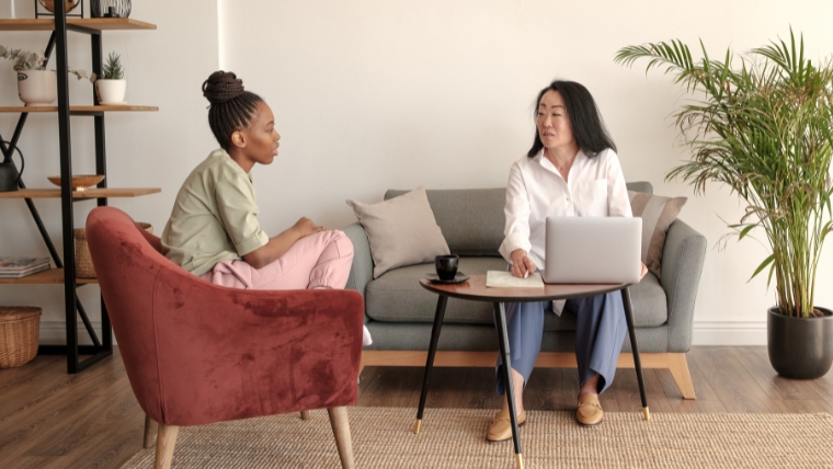 A psychiatrist and patient sitting together and discussing mental health | Preventive Depression Screenings Help Deliver Treatment, Ease Stigma | Mindful Health Solutions