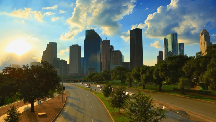 A view of the Houston skyline with the sun peaking through the clouds | The Top Mental Health Professionals and Psychiatry Services in Houston | Mindful Health Solutions