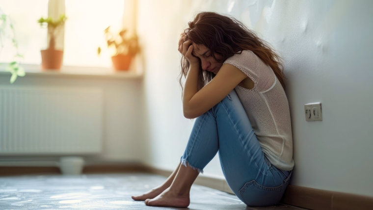 A woman sitting on the floor in the middle of an anxiety attack Anxiety Attack or Panic Attack How To Tell the Difference | Mindful Health Solutions