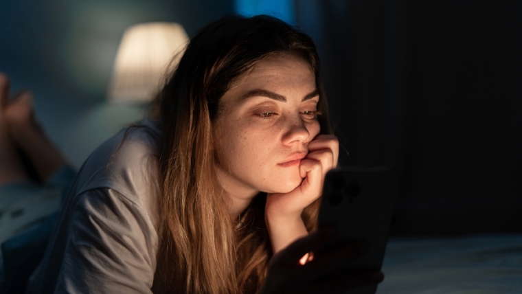 4 Ways Information Tired woman on smartphone at night in bed | 4 Ways Information Overload Impacts Our Mental Health and How To Cope | Mindful Health Solutions