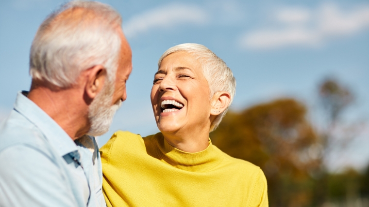 Mature couple outside happy and laughing | How TMS Therapy is Transforming Fibromyalgia Treatment for Good | Mindful Health Solutions