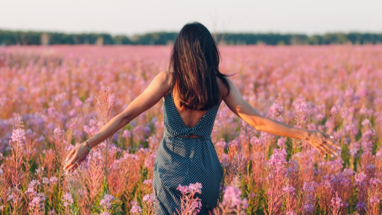 Woman in a field of purple flowers | Ditch the Chocolates Why Your Mental Health Matters This Valentine's Day | Mindful Health Solutions
