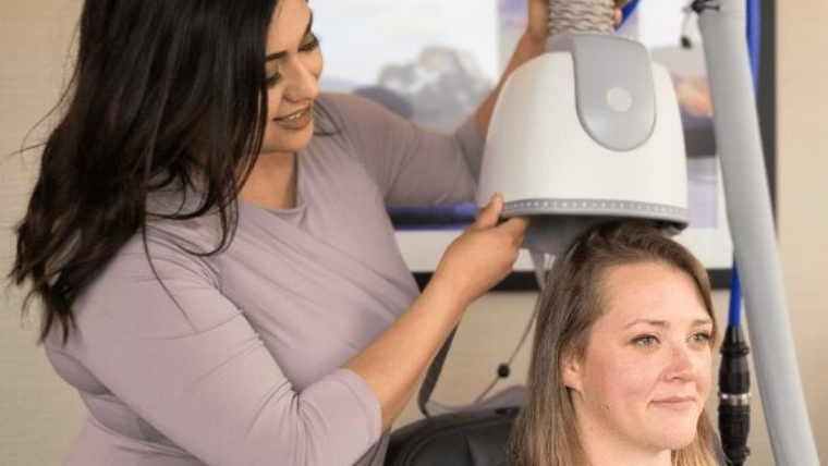 Woman providing TMS therapy treatment to a patient | It's Not Brain Zapping Debunking the 5 Myths of TMS Therapy | Mindful Health Solutions