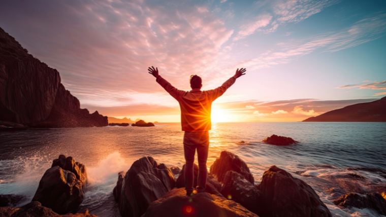 Man with Arms Outstretched at Mountainous Coastline | 8 Ways Ketamine Infusion Therapy Can Transform Your Anxiety | Mindful Health Solutions