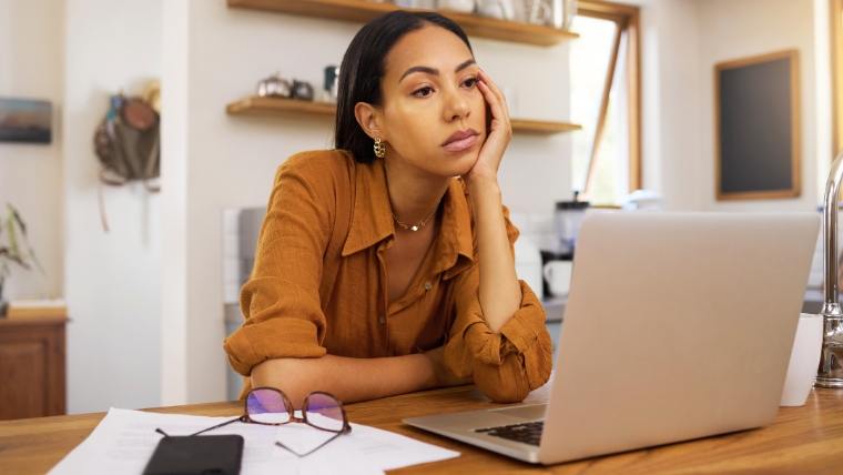 Woman feeling overwhelmed and anxious about work while staring at her laptop | Is Your Perfectionism Helping or Hurting You Healthy vs. Harmful Traits | Mindful Health Solutions