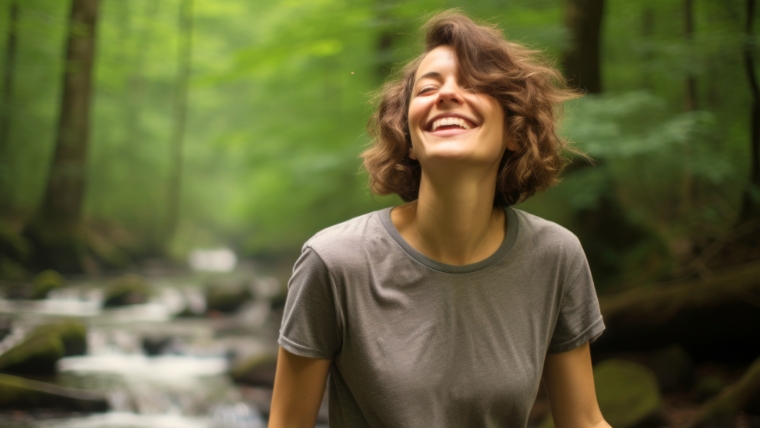 Woman outside in nature looking happy | Boost Your Mental Health Treatment Success with Accelerated TMS | Mindful Health Solutions