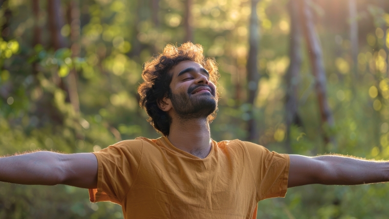 A man standing outside with his arms out and face pointing up with a look of relief and joy | Tried Everything Else for Depression Discover How TMS Can Help | Mindful Health Solutions